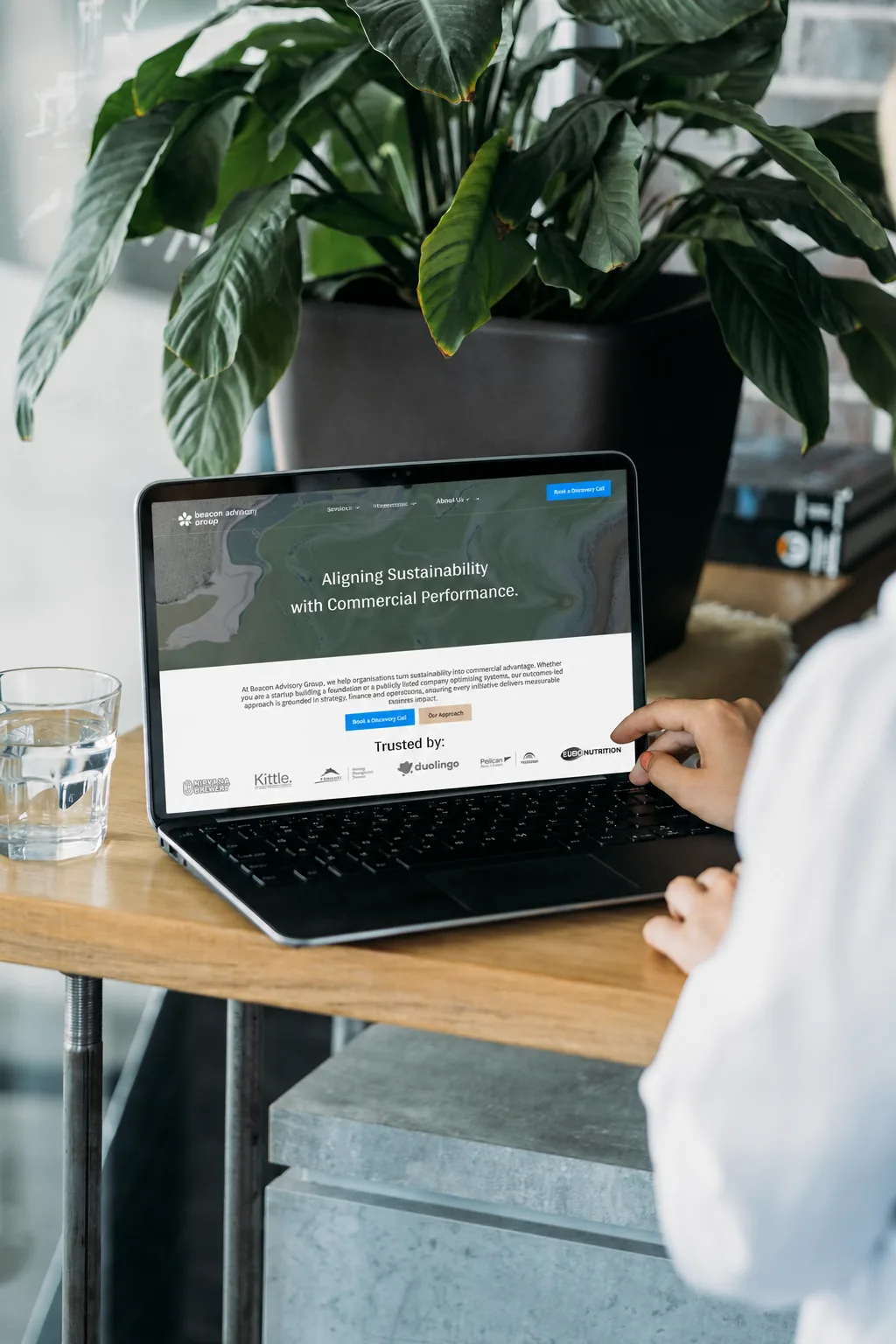Beacon Advisory Group website on a laptop